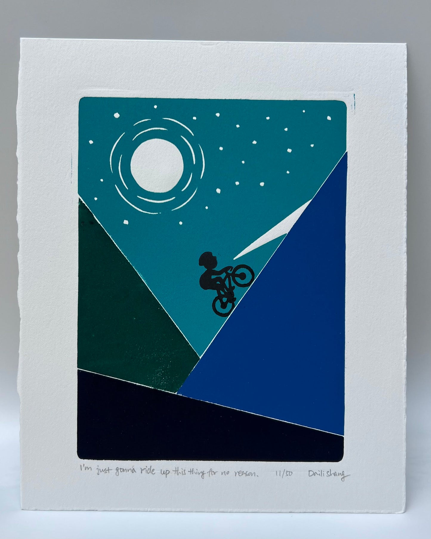 cyclist on a road bike riding uphill in the dark